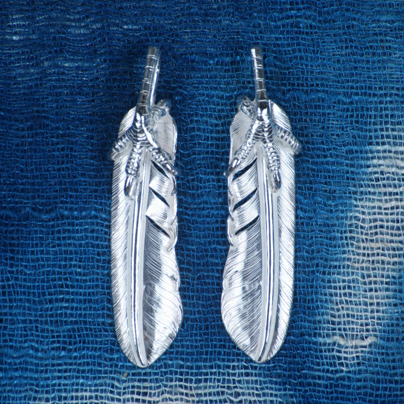 Eagle Talon Life Feather, front view, with a talon gripping the quill